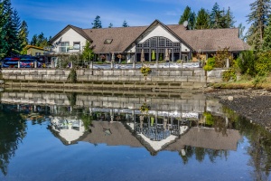 a seaside restaurant reflecting on calm waters in HDR